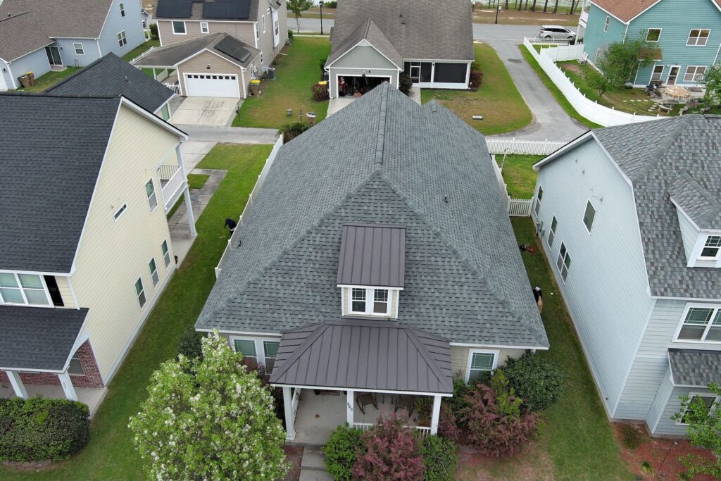 BEFORE: The original roof shows heavy streaking, uneven wear, and shingles nearing the end of their service life — early signs that a roof leak was only a matter of time.