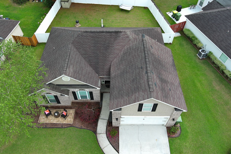 A close aerial inspection view showing shingle condition and roofline detail.