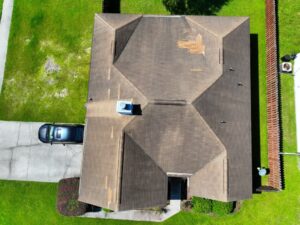 Before faded shingles, algae streaks and mismatched repair patches before the full roof replacement in Savannah, G