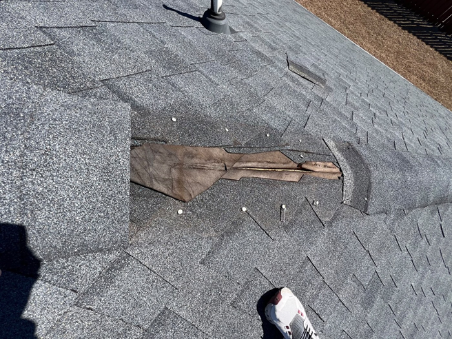 Exposed underlayment from missing shingles is a common finding during a storm damage inspection.